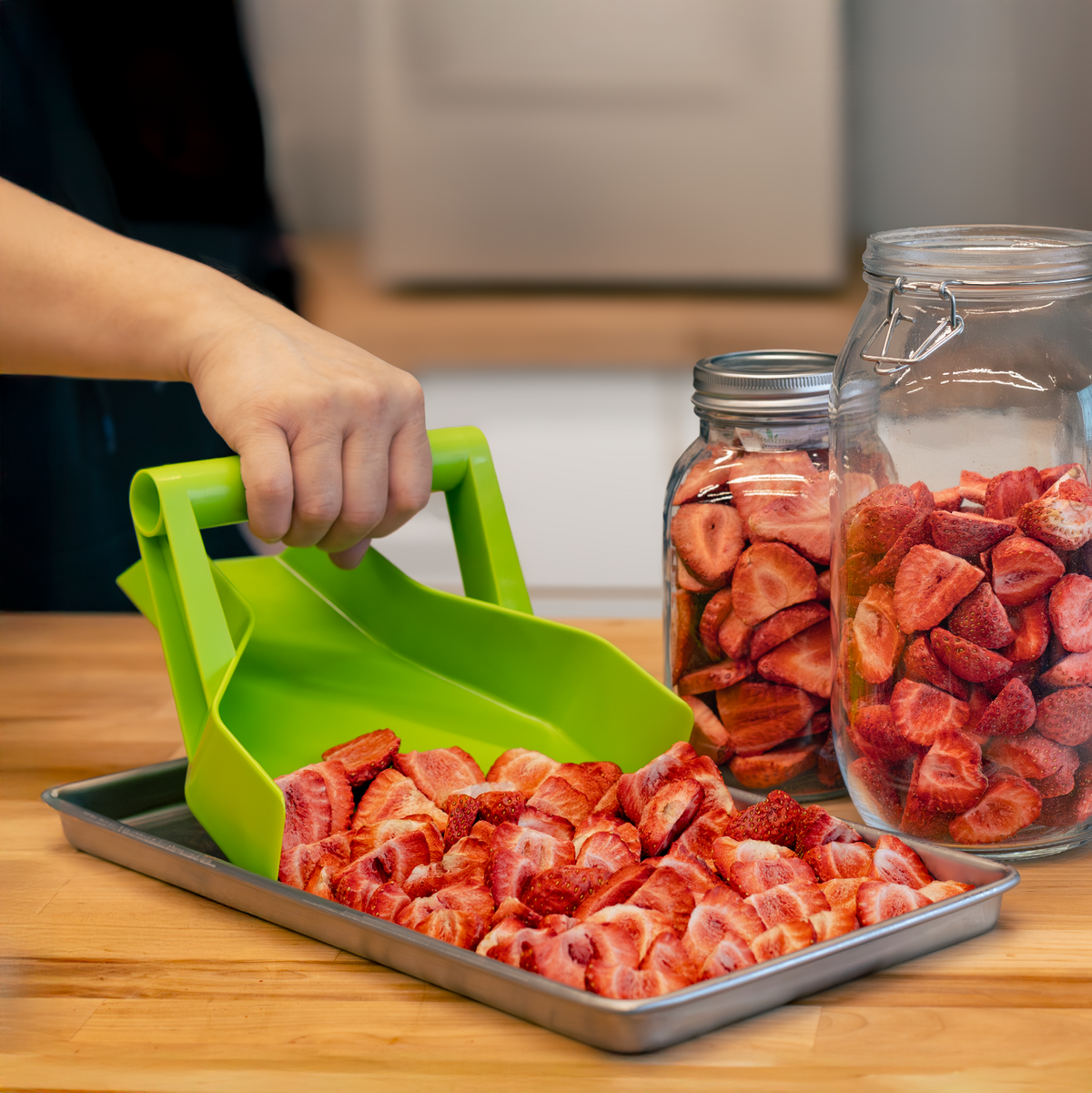 Harvest Right Tray Scoop pouring freeze-dried strawberries into jars